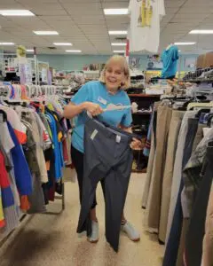 Volunteer assisting with merchandise inside a Molly Mutt Thrift Shop at Brevard Humane Society